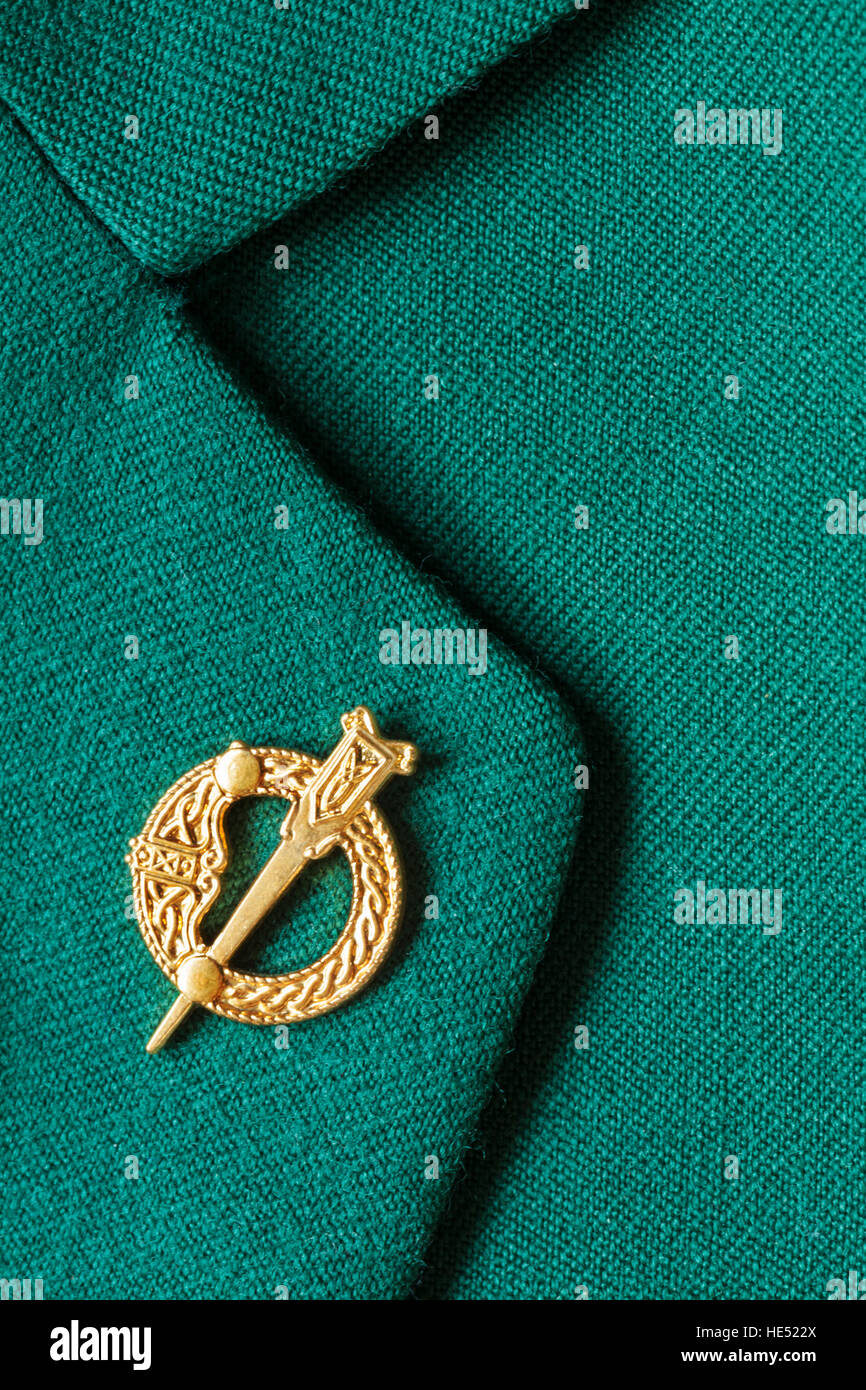 Irish pin Tara brooch as worn by the high Kings and Queens of Ireland on lapel of green jacket Stock Photo