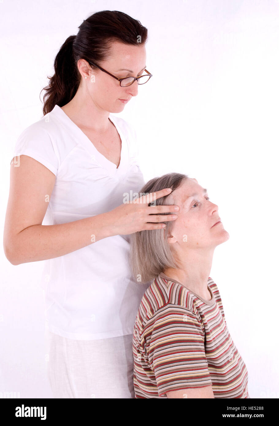 Retired Woman Older Than 60 Years Getting A Head Massage Stock Photo retired-woman-older-than-60-years-getting-a-head-massage-stock-photo