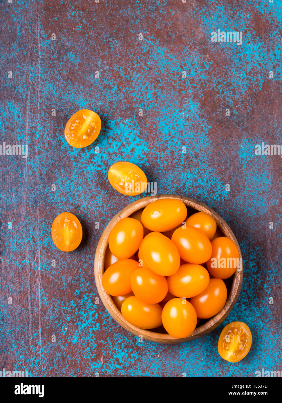 Yellow cherry tomatoes in a wooden bowl Stock Photo - Alamy