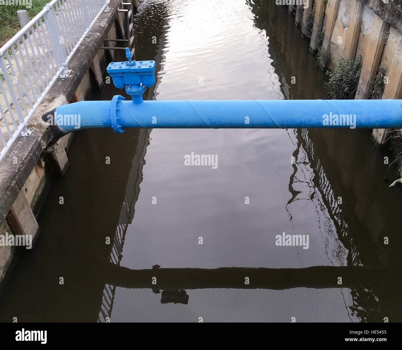 Large air valve of the metal pipe which cross the canal in the urban area Stock Photo Alamy