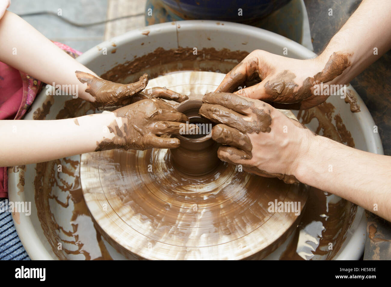 Moulding of a clay pot on a potter's wheel hands Stock Photo Alamy