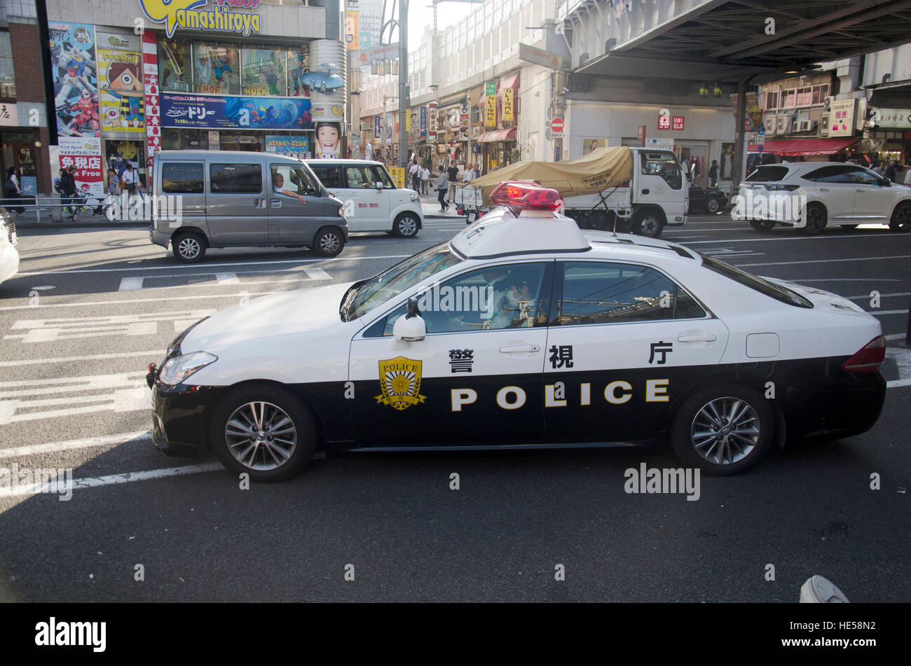 Japanese policemen people driving cop car on the road check over everything on traffic road at JR tokyo station on October 20, 2016 in Tokyo, Japan at Stock Photo