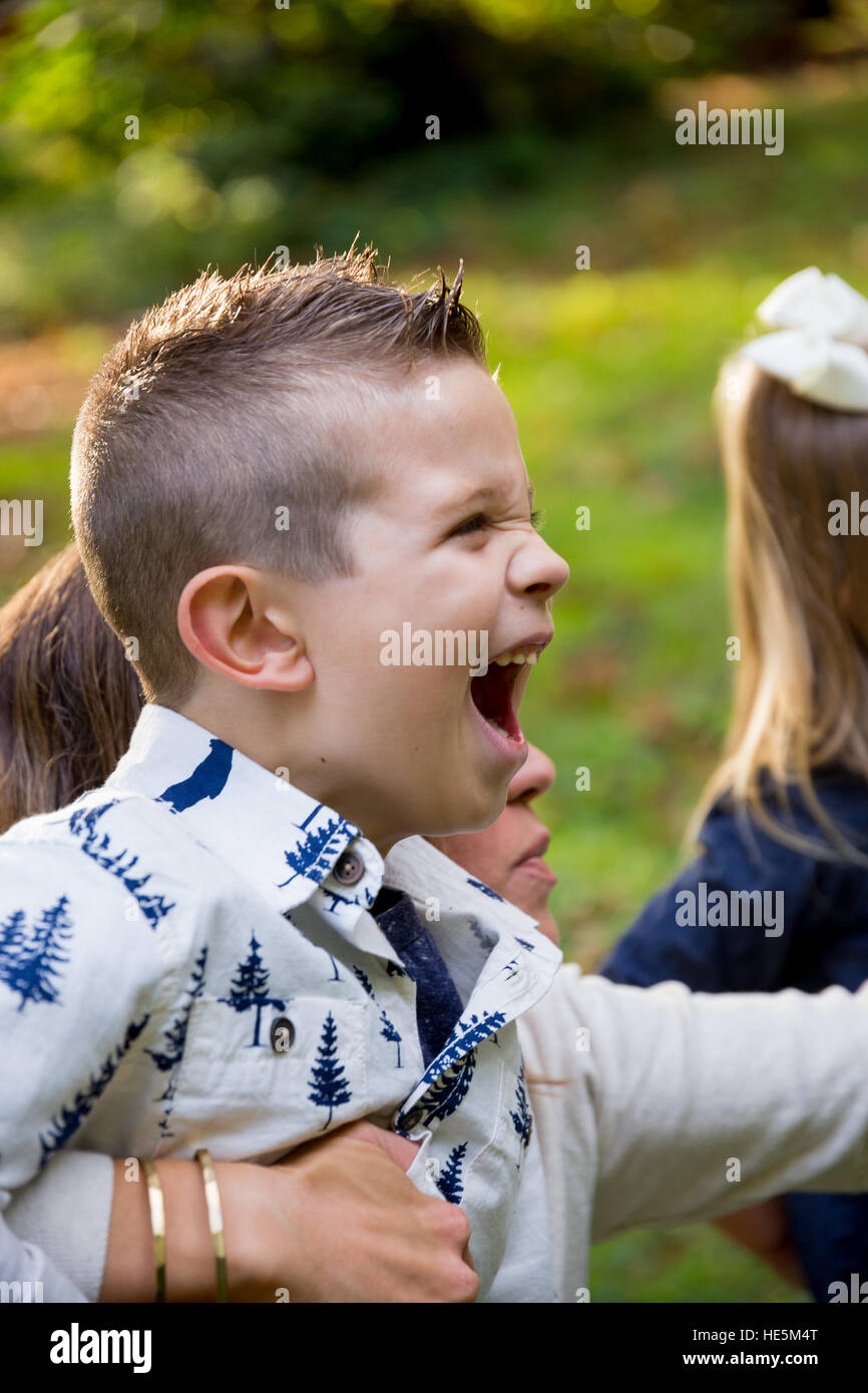 Lifestyle portrait of a young mom laughing and playing with her son at a nature park in Oregon. Stock Photo