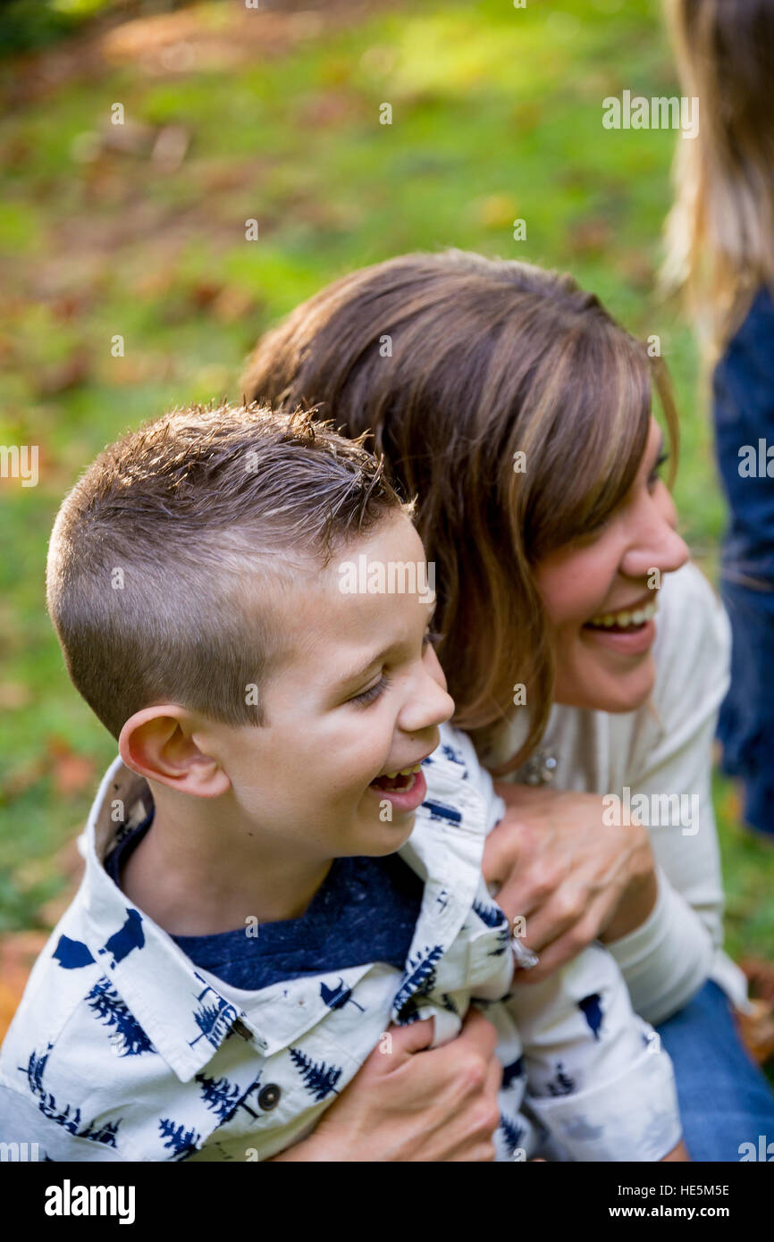 Lifestyle portrait of a young mom laughing and playing with her son at a nature park in Oregon. Stock Photo