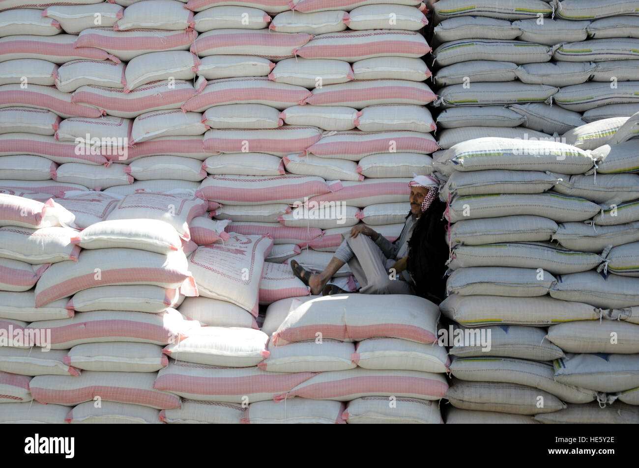 Sanaa, Yemen. 17th Dec, 2016. A man takes a rest on bags of wheat at a mill in Sanaa, capital of Yemen, on Dec. 17, 2016. Wheat market and mill centers fear an escalated famine after the biggest wheat trader has stopped new wheat imports due to a crisis at the central bank. Wheat price was about 25 percent higher in November on average across Yemen than they were before the ongoing conflicts. © Mohammed Mohammed/Xinhua/Alamy Live News Stock Photo