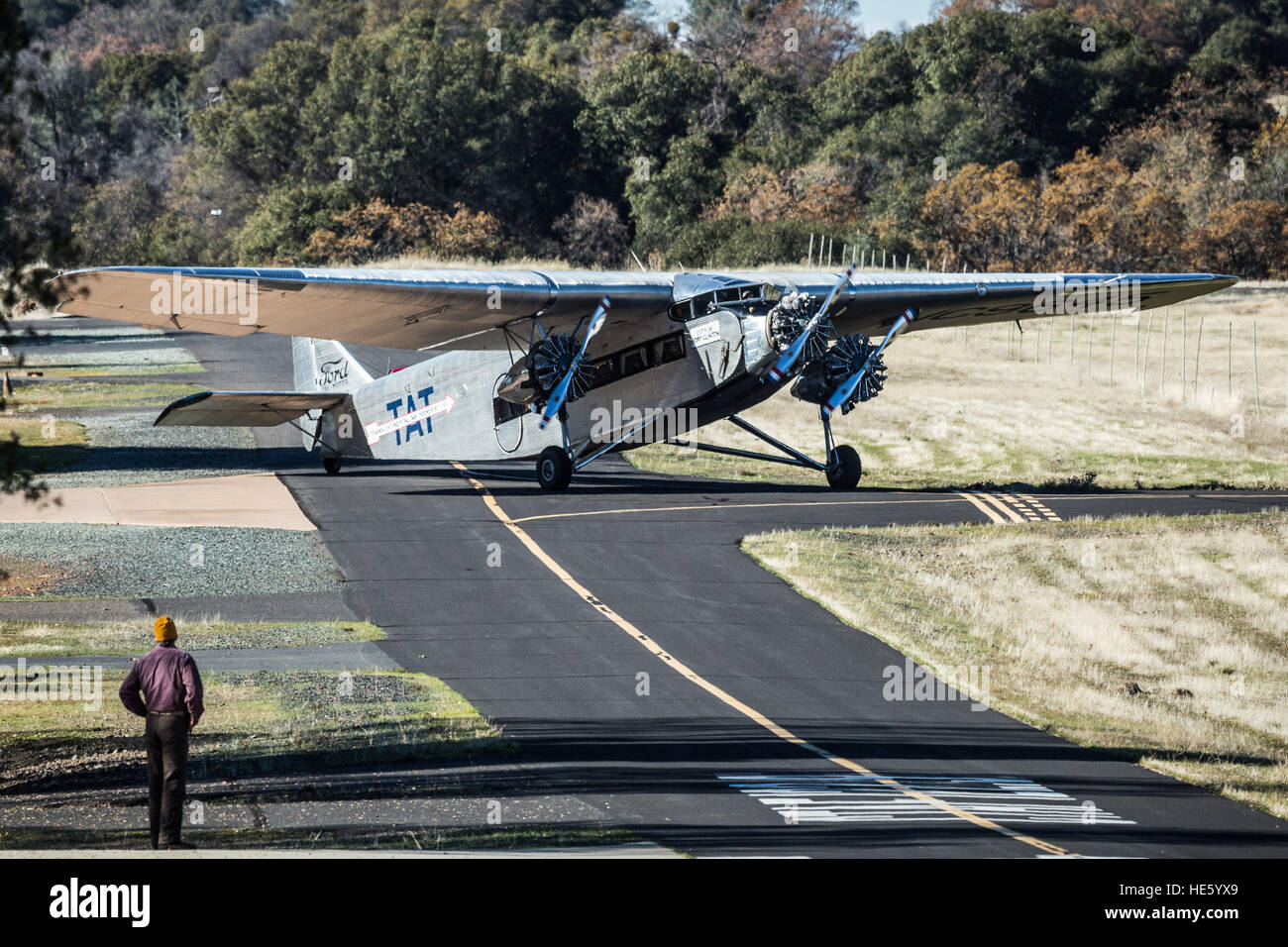 Groveland, California, USA. 17th Dec, 2016. Saturday, December 17, 2016.An unidentified man watches as a 1928 Ford Tri-Motor airplane lands at the Pine Mountain Lake Airport in Groveland, California.This Ford Tri-Motor NC9645, nicknamed The Tin Goose, has a wingspan of 77 feet 6 inches and was constructed in 1928. It was named the City of Wichita, and it was used to introduce the first coast-to-coast passenger air/rail service in the United States on July 7, 1929, and the development and inauguration of the first all air passenger service on October 25, 1930. The plane can carry up to 1 Stock Photo