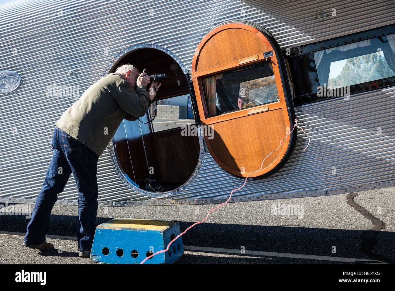 Groveland, California, USA. 17th Dec, 2016. Saturday, December 17, 2016.Tim Dorner, of Sonora, California, takes photos of the interior of a 1928 Ford Tri-Motor airplane, currently offering flights from the Pine Mountain Lake Airport in Groveland.This Ford Tri-Motor NC9645, nicknamed The Tin Goose, has a wingspan of 77 feet 6 inches and was constructed in 1928. It was named the City of Wichita, and it was used to introduce the first coast-to-coast passenger air/rail service in the United States on July 7, 1929, and the development and inauguration of the first all air passenger service Stock Photo