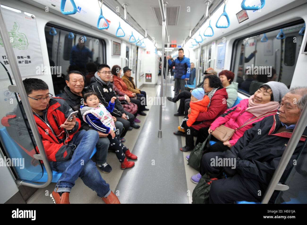 Qingdao, China's Shandong Province. 18th Dec, 2016. Passengers take the subway line 3 in Qingdao, east China's Shandong Province, Dec. 18, 2016. Qingdao's subway line 3, the first subway line in Shandong Province, was officially opened on Sunday. © Zhang Jin'gang/Xinhua/Alamy Live News Stock Photo