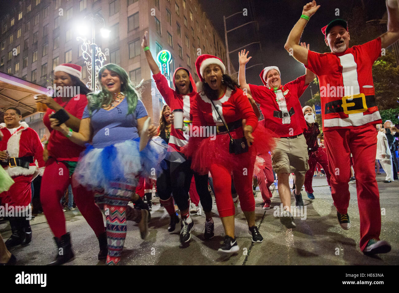 New Orleans, USA. 17th Dec, 2016. Costumed Santas'  break the start line during the 6th Annual Running of the Santas festival in New Orleans, La. on Saturday, Dec. 17, 2016. The Running of the Santas is now a national, annual bar tour that started with 40 Santas in Philadelphia with the goal to raise money for local charities. Credit: JT Blatty/Alamy Live News Stock Photo