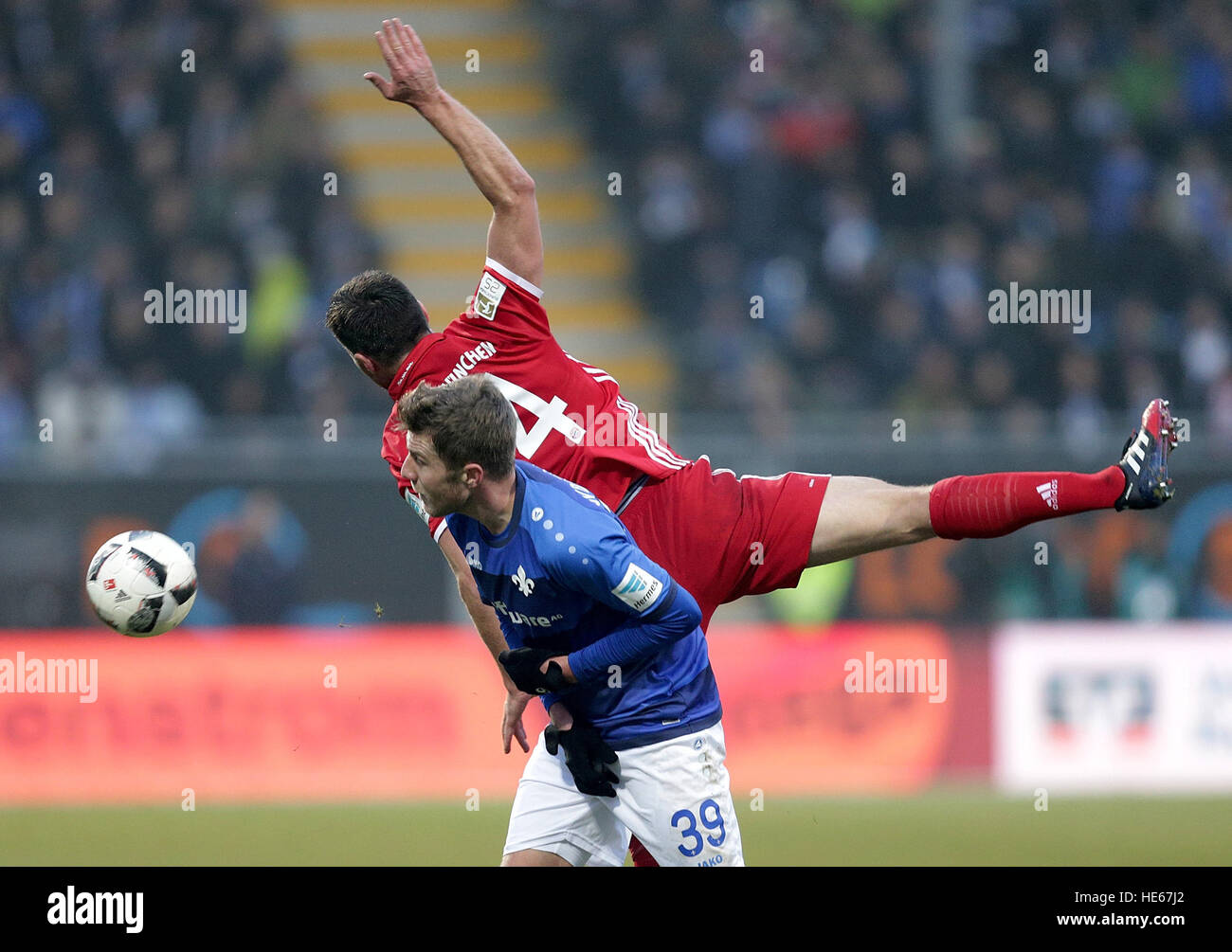 Darmstadst, Germany. 18th Dec, 2016. Darmstadt's Sven Schipplock and Munich's xabi Alonso compete for the ball during the Bundesliga soccer match between Darmstadt 98 and Bayern Munich at Jonathan Heimes stadium in Darmstadst, Germany, 18 December 2016. Photo: Hasan Bratic/dpa/Alamy Live News Stock Photo
