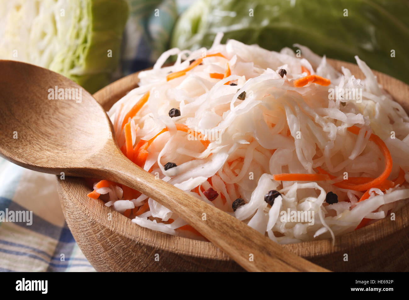 sauerkraut and carrots in a wooden plate macro horizontal, rustic style Stock Photo