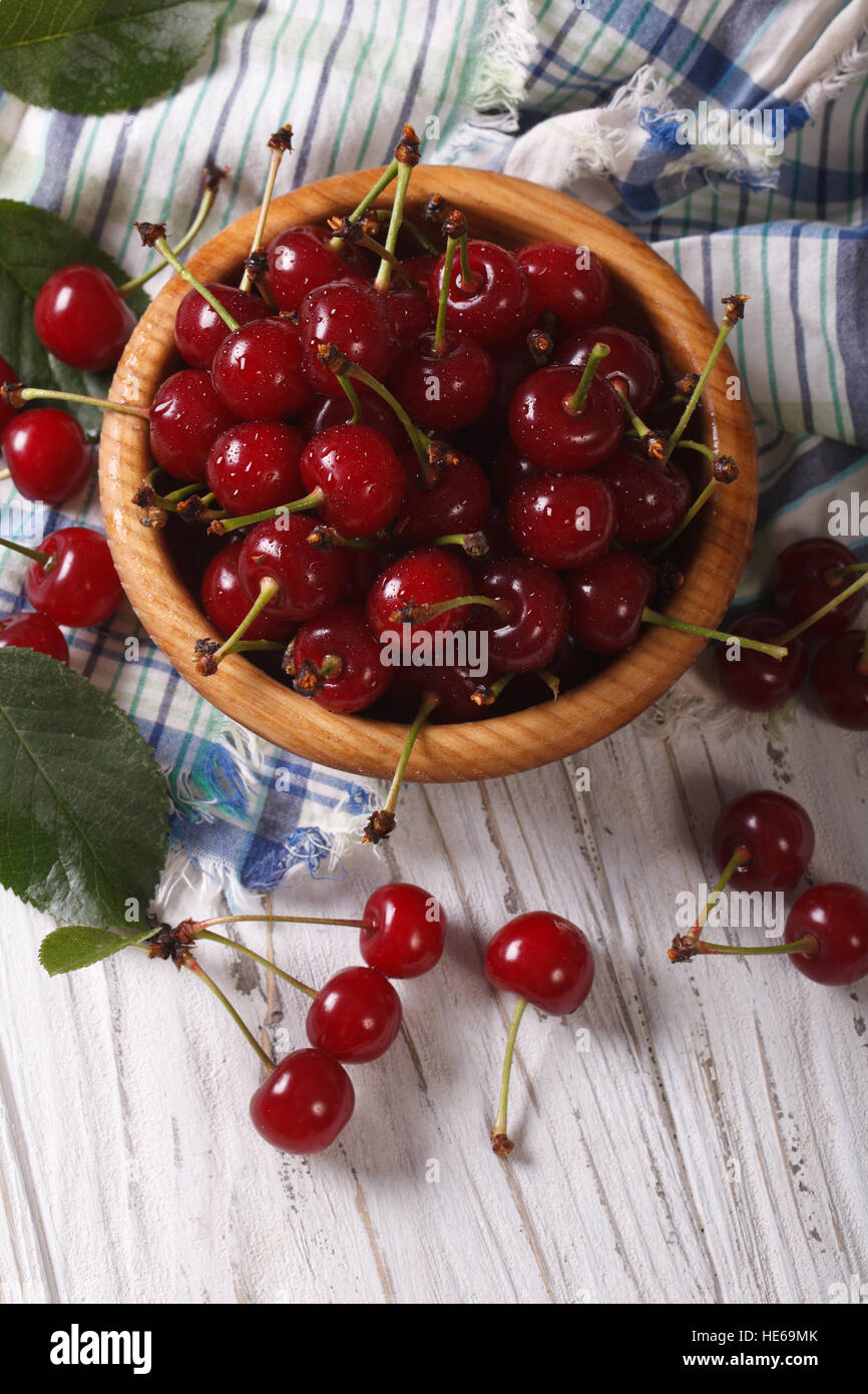 Ripe juicy cherries in a wooden bowl closeup. vertical view above ...