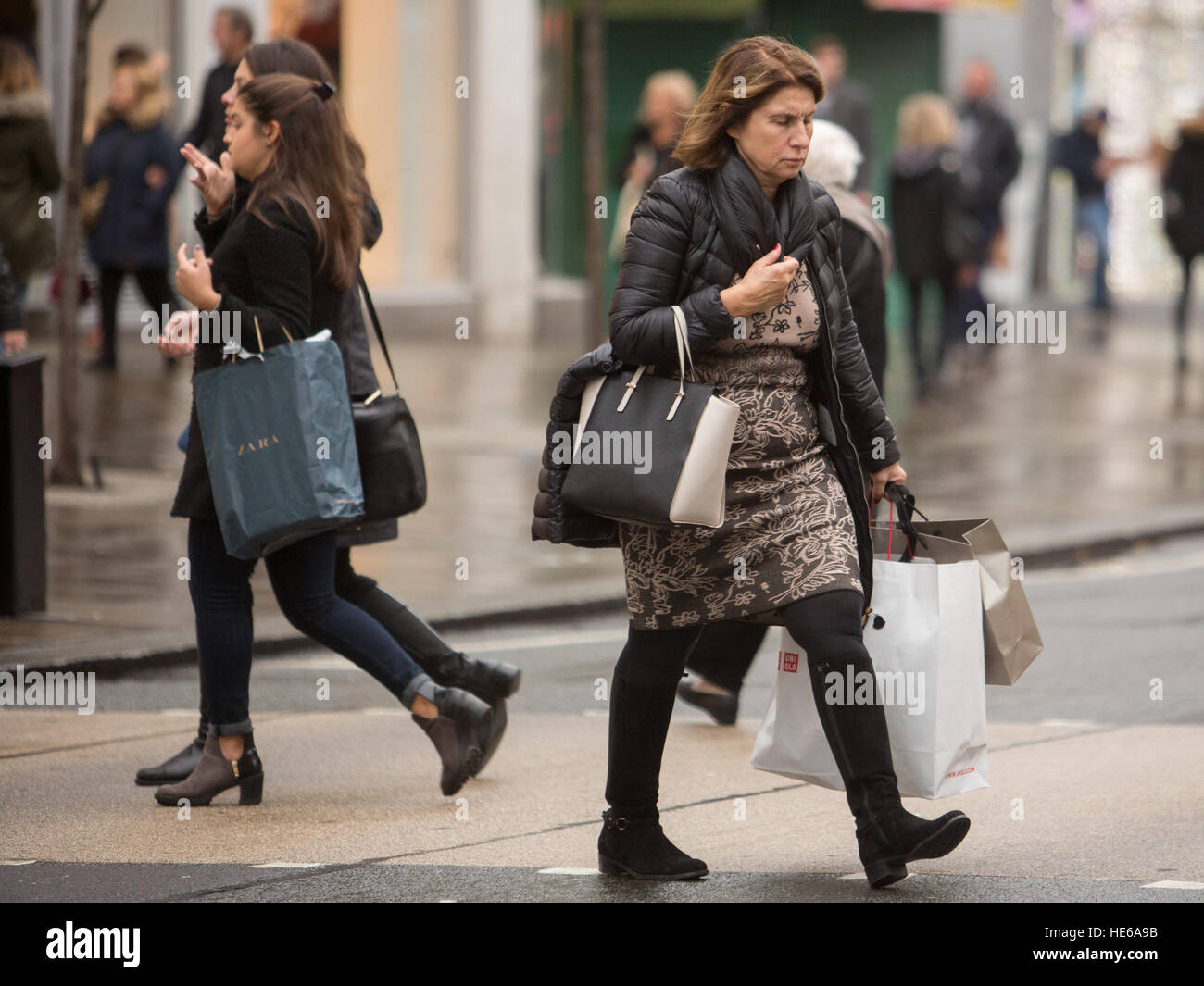 Shoppers with shopping bags Christmas Oxford Street London UK