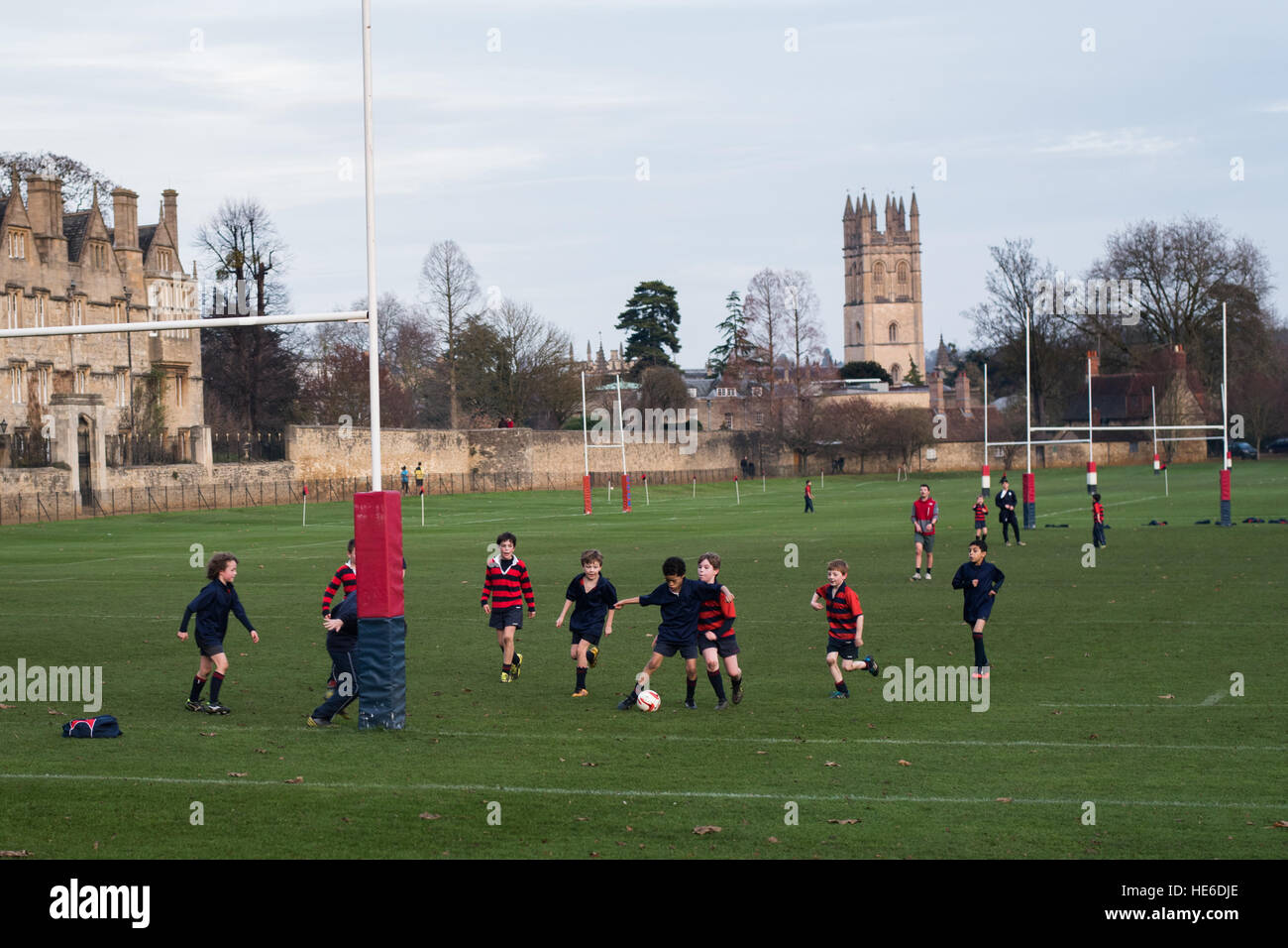 Children from Christchurch Cathedral School, Oxford playing football on playing fields with