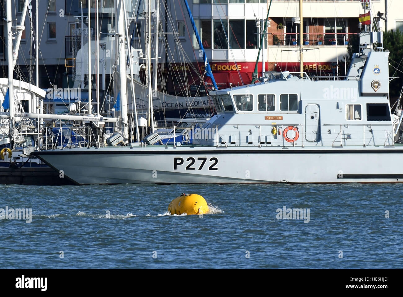Royal Navy bomb squad and divers tow out a 500lb German bomb from Portsmouth Harbour with a rib, with the bomb underwater below the yellow bouy. The bomb was discovered while dredging was being done in preparation for the new aircraft carriers next year. Stock Photo