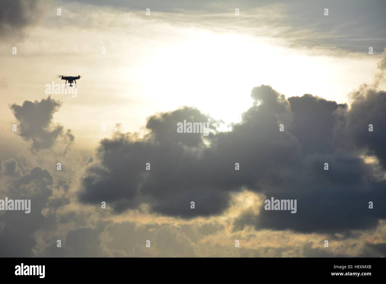 Drone flying over bright sky during a sunset Stock Photo - Alamy
