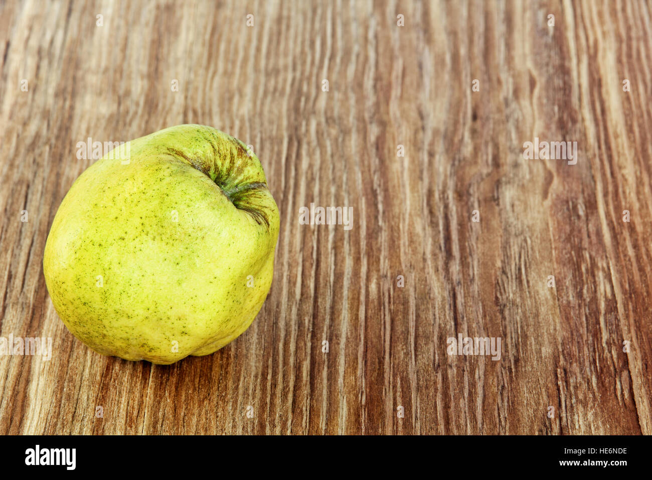 Appetizing ripe quince on grunge wooden background. Stock Photo