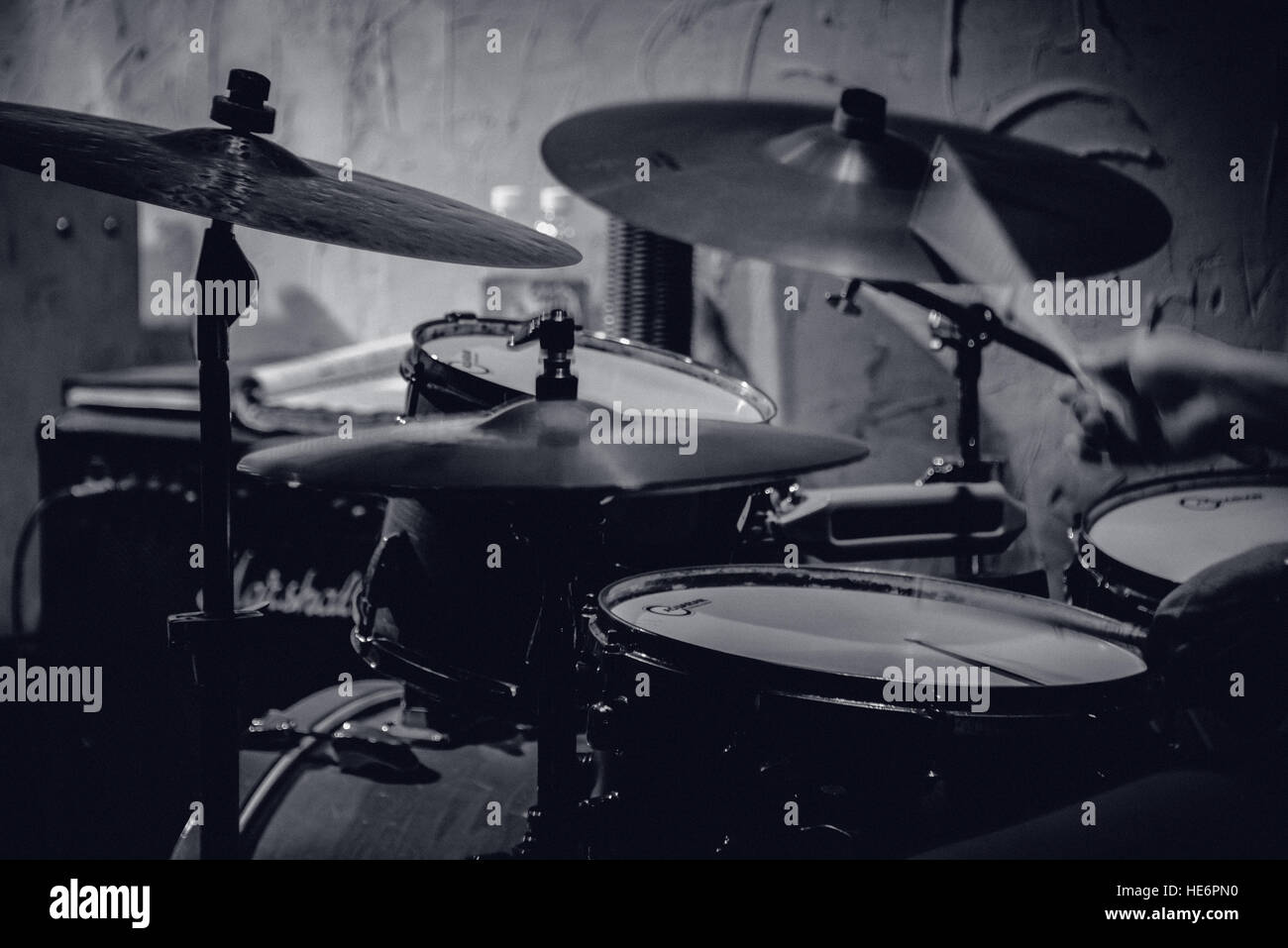 Drummer drumming on Jazz kit in black & white, hands and sticks Stock Photo