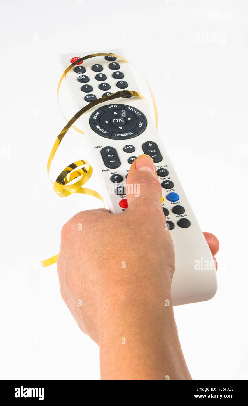 hand holding a remote control in a festive gold ribbon on white