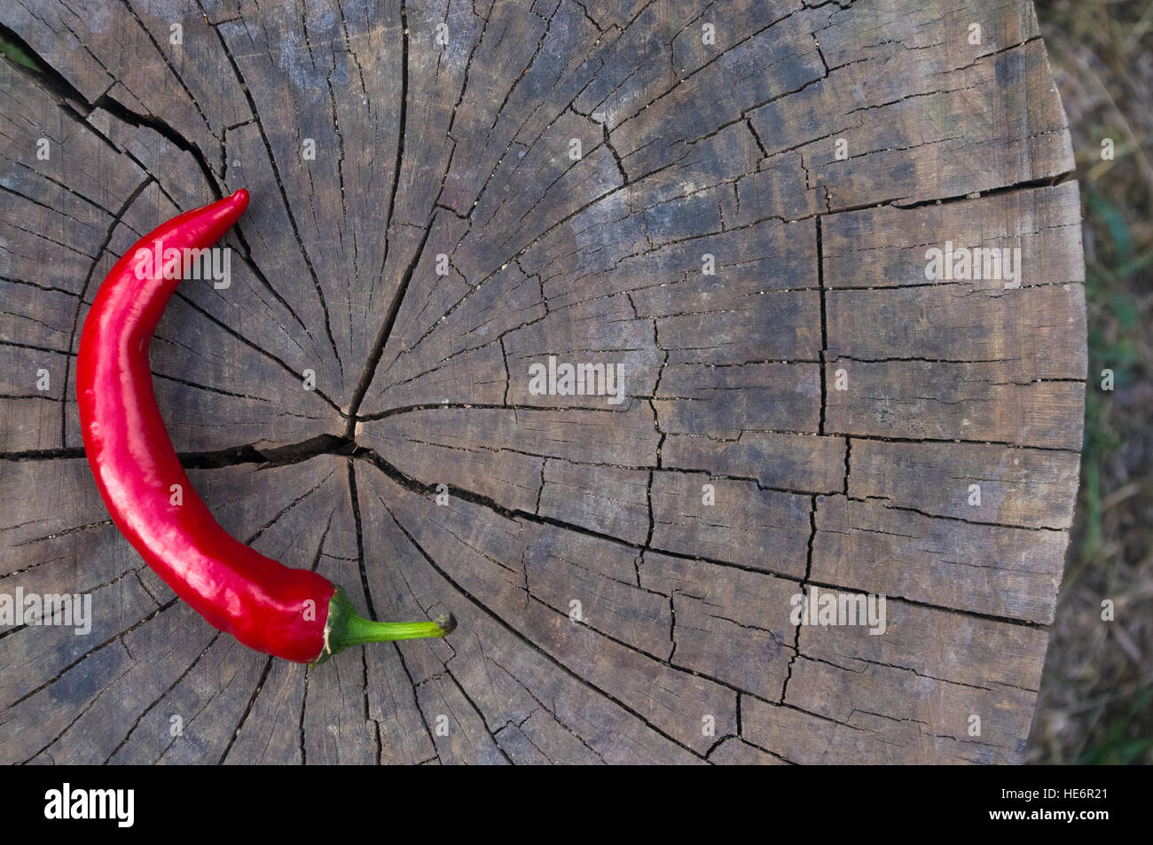 A pod of red hot chili peppers on the old worn wooden background Stock ...