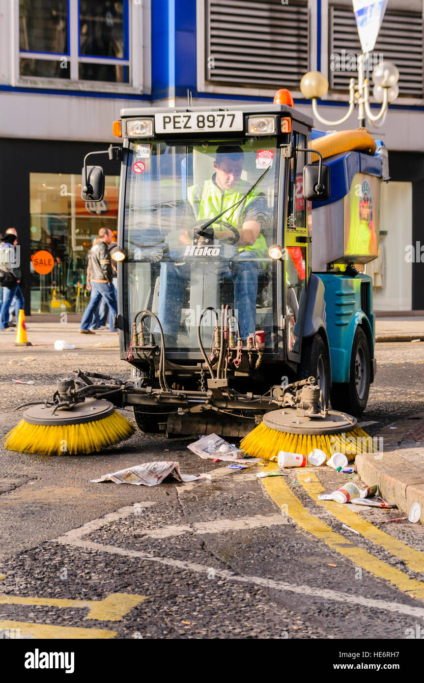 A small road sweeper collects litter in Belfast. Stock Photo