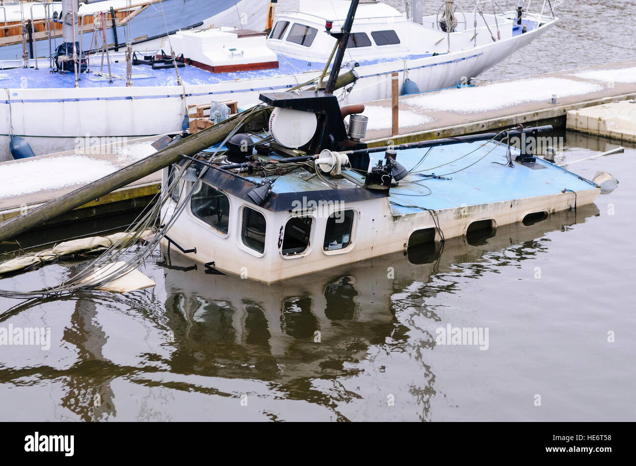 Shipwrecked boat in a harbour marina Stock Photo