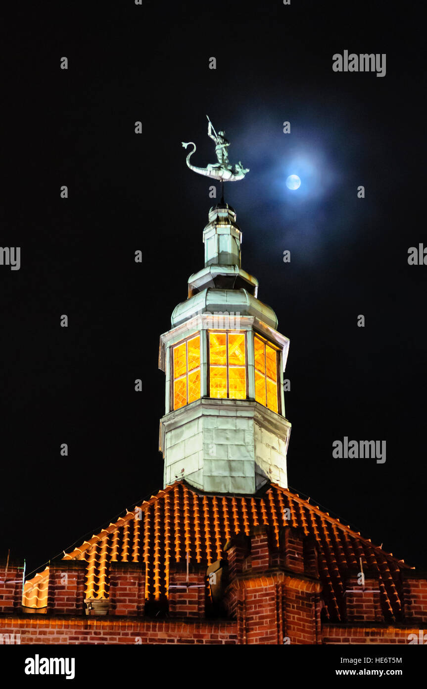 Copper skylight on the roof of a building in Gdansk, with the moon behind. Stock Photo