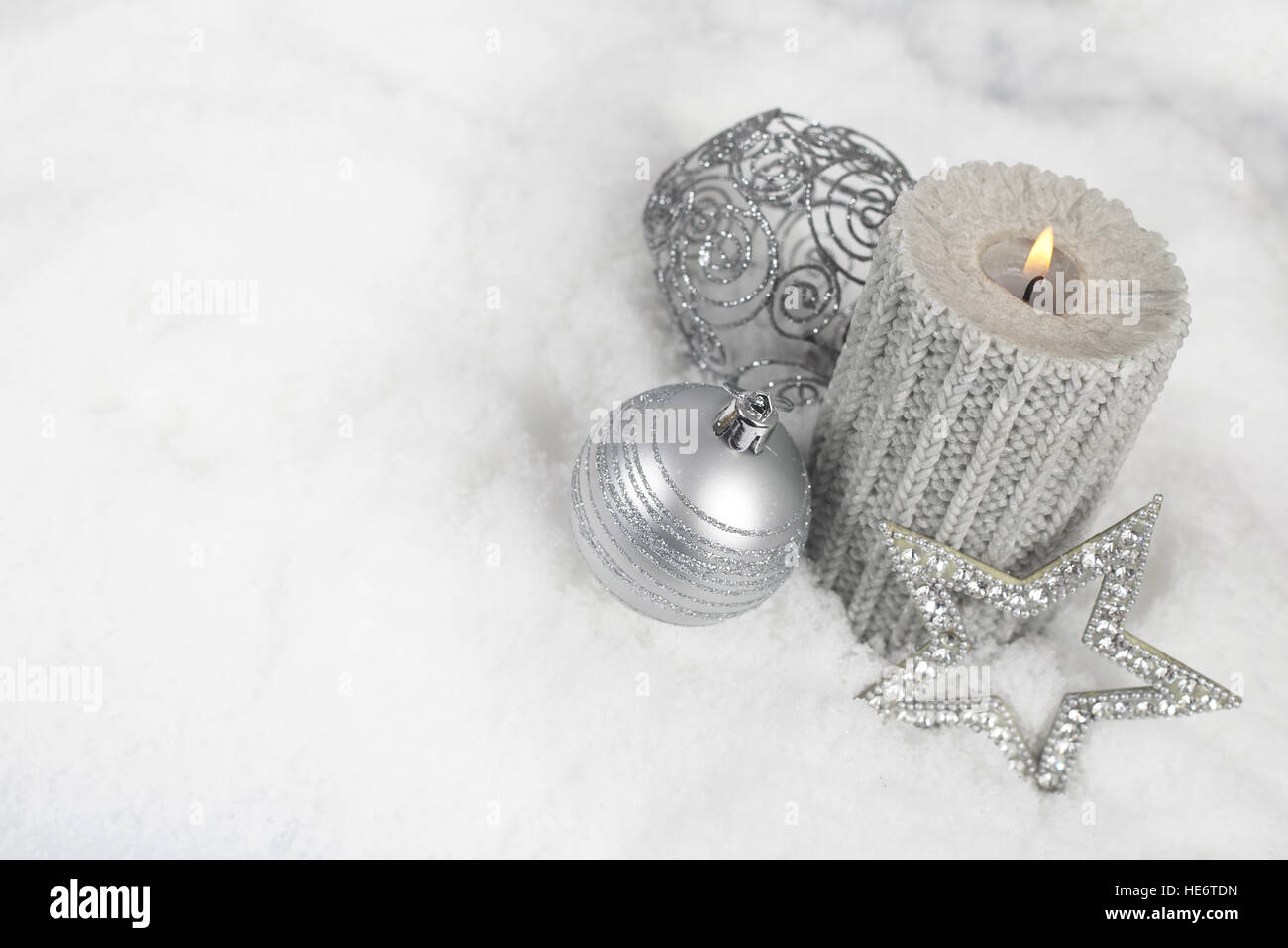 Silver christmas baubles in the snow hi-res stock photography and ...