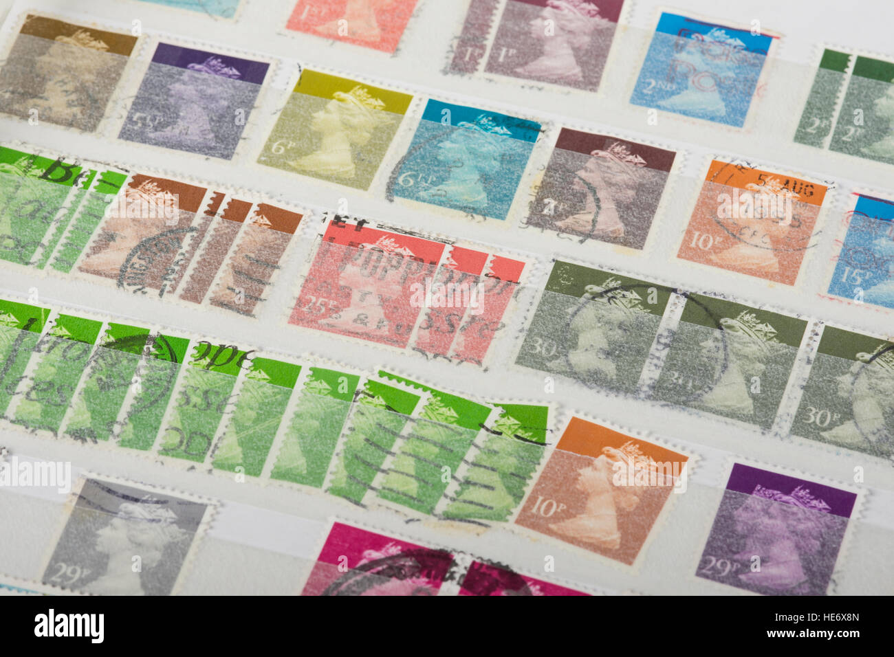 some old UK postage stamps in a collection album Stock Photo