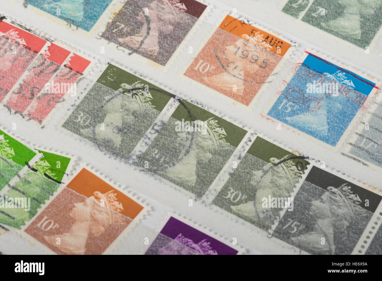 some old UK postage stamps in a collection album Stock Photo