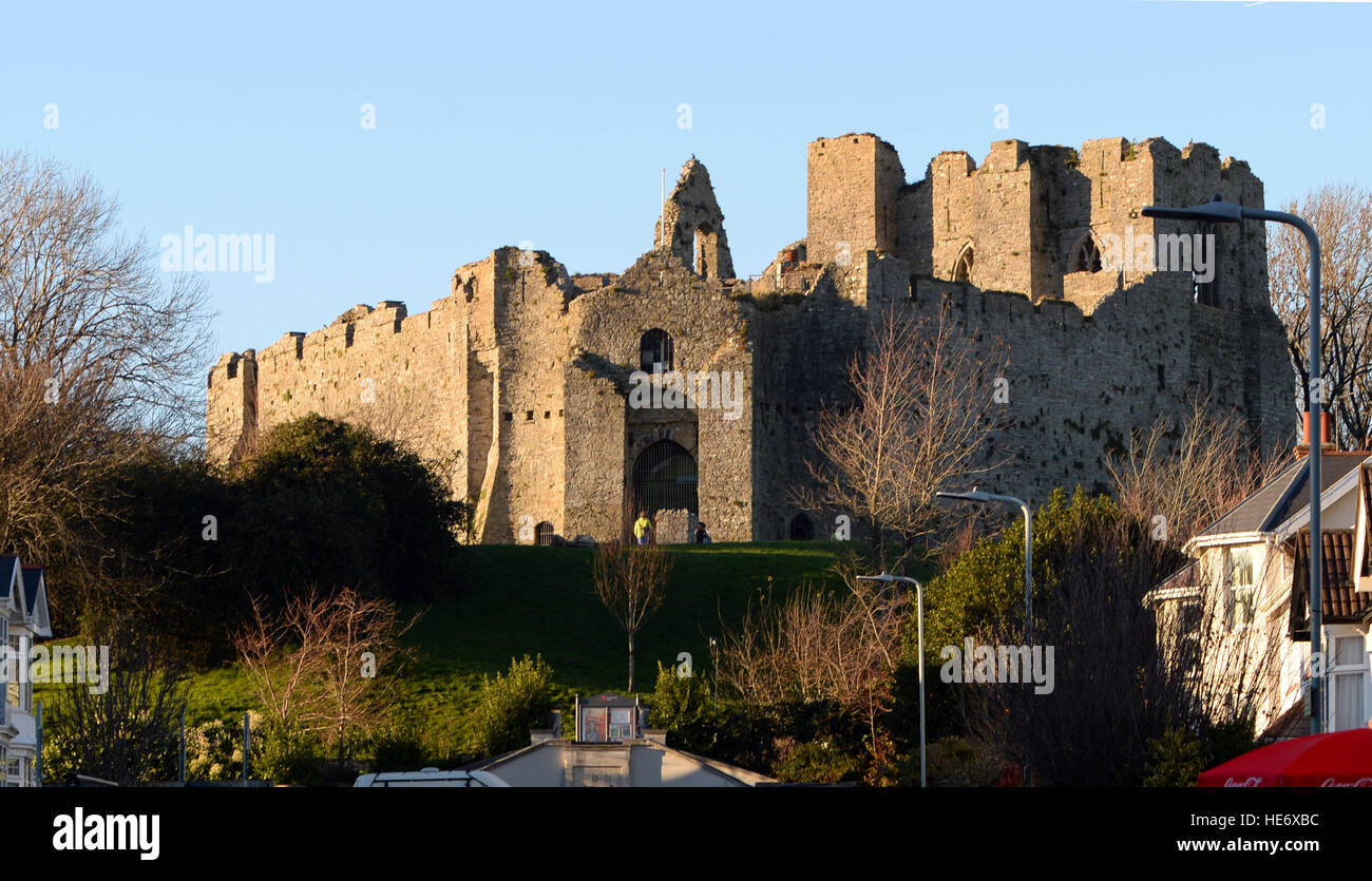 Oystermouth castle ruins with its walls, towers and halls presides over the village of Mumbles, Swansea, South Wales surrounded by houses on a hill. Stock Photo