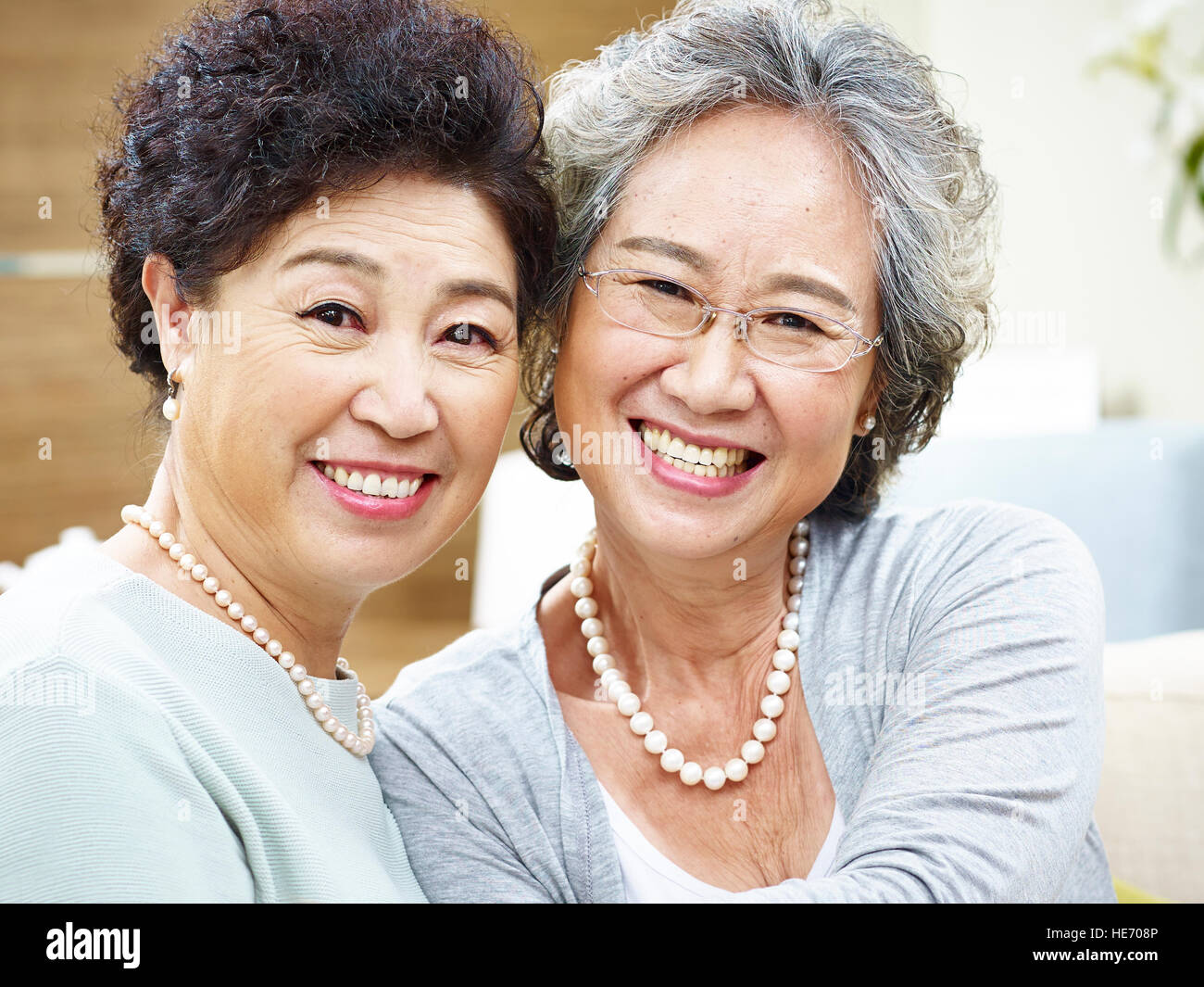 close-up portrait of a happy senior asian couple looking at camera smiling. Stock Photo