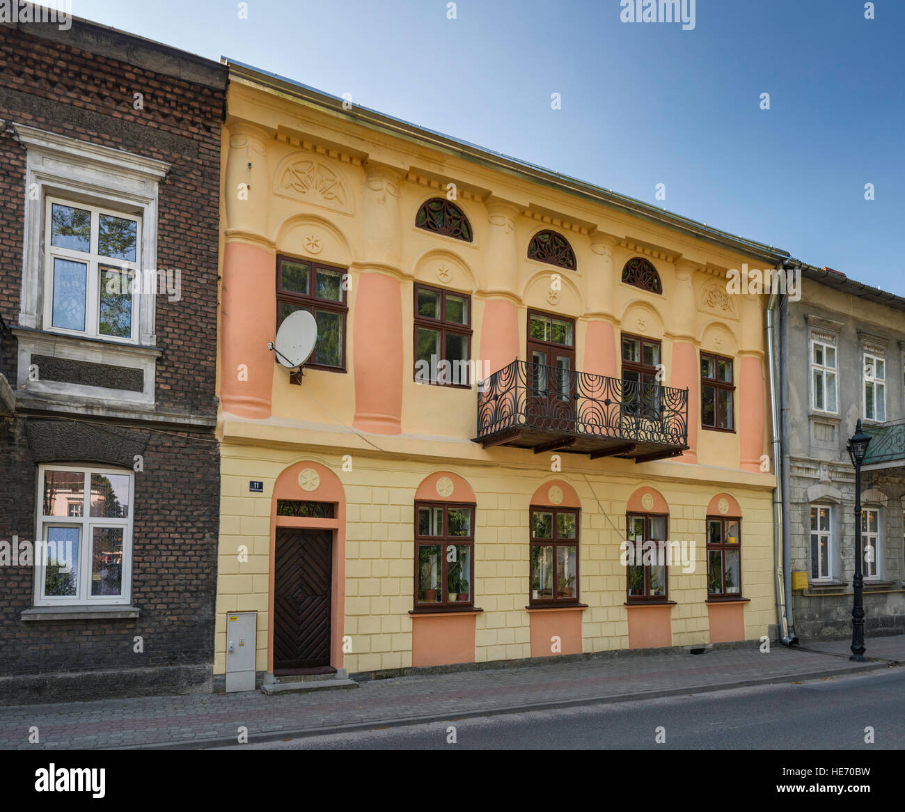 Apartment house with balcony using metal elements removed during WW2 from bimah at synagogue, in Lesko, Bieszczady region, Malopolska, Poland Stock Photo