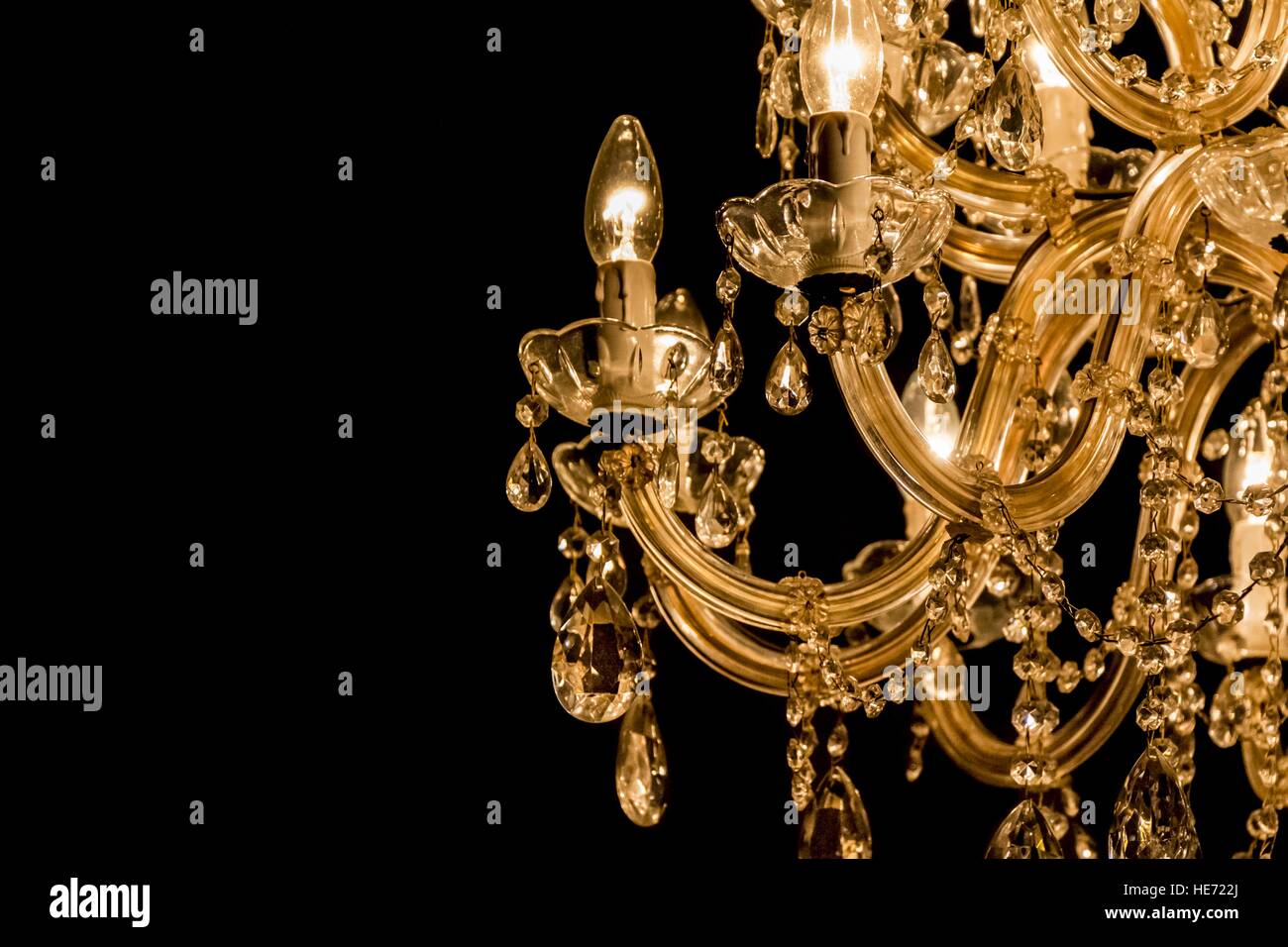 Gallant chandelier with light candles and dark side background. Luxury  candelabra hanging on ceiling with lots of little gems. Black background  Stock Photo - Alamy