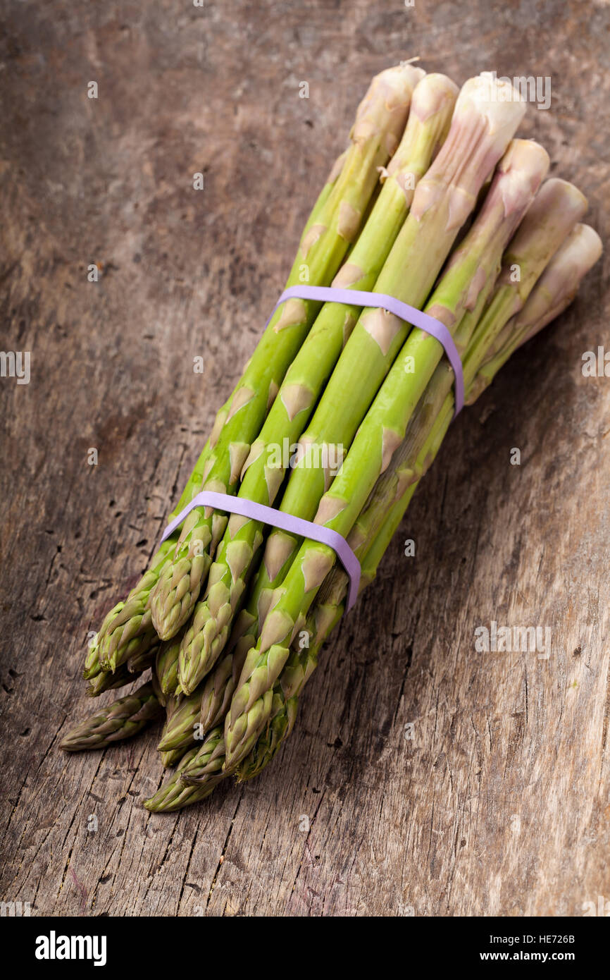 Bunch of fresh asparagus on wooden table. Stock Photo