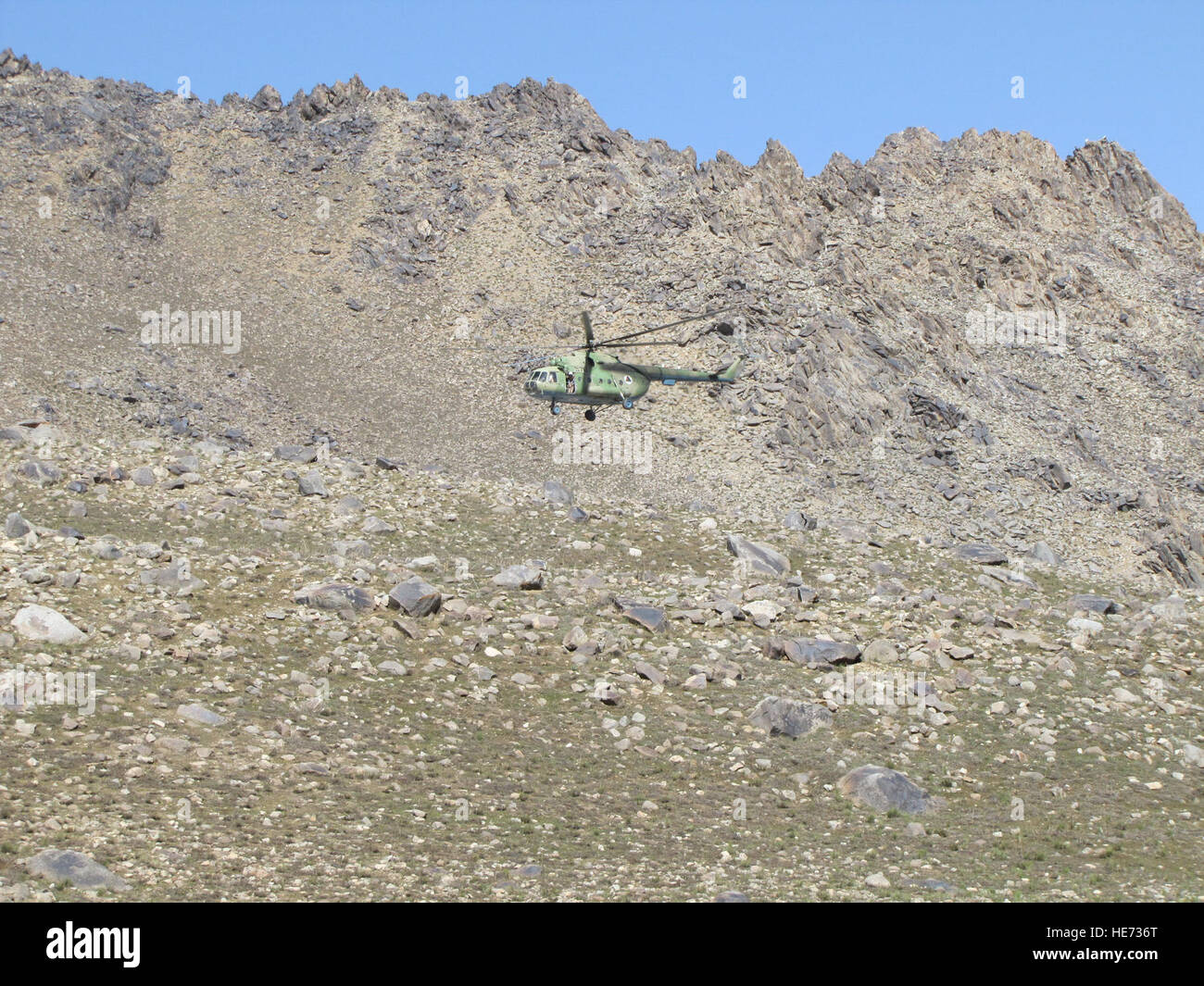 Afghan National Army Air Corps Mi-17 prepares to land in a landing zone at an elevation of 12,000 feet, May 22. This is the closest aircraft could land safely to get the needed supplies to conduct recovery efforts of the Pamir Airlines passenger jet that crashed, Monday, May 24. There were no survivors among the 38 passengers and 5 crew. Stock Photo