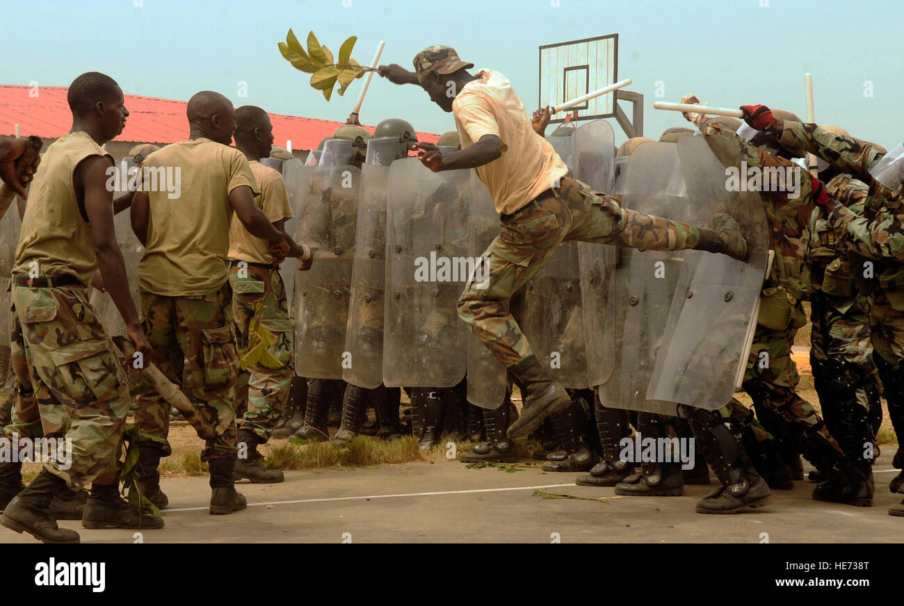 MONROVIA, Liberia--An Armed Forces of Liberia personnel, posing as a rioter, kicks a shield during a non-lethal weapons skills demonstration at Edwin Binyah Kesselly Military Barracks, Liberia March 13. 232 AFL soldiers participated in the three-week training provided by U.S. Marines from Special Purpose Marine Air Ground Task Force 12, Naval Air Station Sigonella, Sicily, Italy.  The course was established to train the AFL on how to assist local police forces in handling large-scale domestic disturbances without resulting to using deadly force.   1st Lt. Mark Lazane) Stock Photo