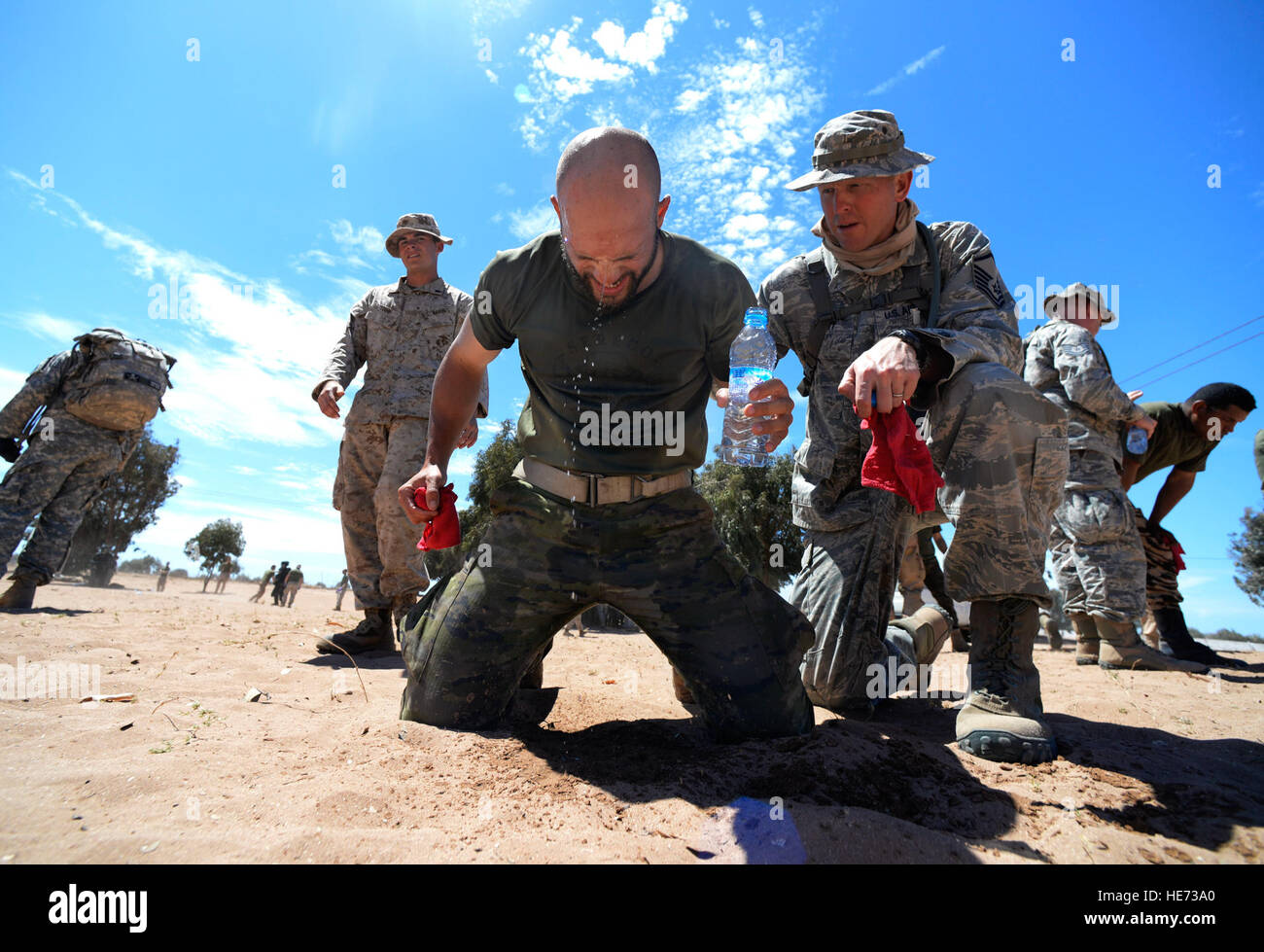 A Spanish Legion soldier recovers with the help of a U.S. Air Force master sergeant after being exposed to Oleoresin Capsicum 'pepper' spray during a non-lethal weapons class as a part of AFRICAN LION 16 at Tifnit, Kingdom of Morocco, April 23, 2016. Of the 11 nations participating in the annual exercise, a group of U.S. military members, Royal Moroccan armed forces members, Spanish Legion soldiers and Royal Netherlands army soldiers lived in field conditions and participated in daily familiarization with other nation’s tactics to improve interoperability.  Senior Airman Krystal Ardrey Stock Photo