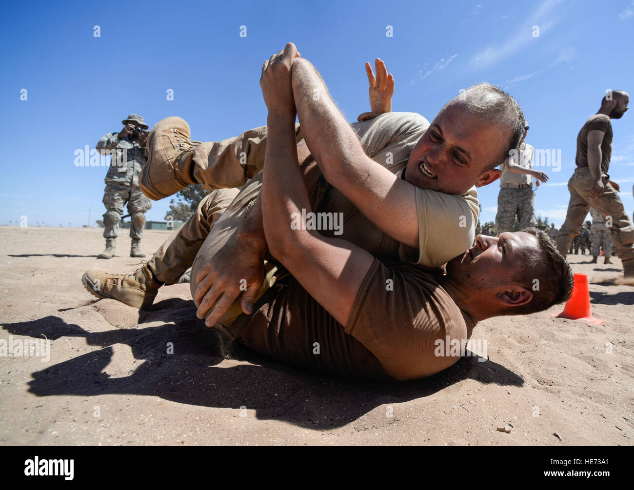 A U.S. Air Force Airman and a Royal Netherlands soldier wrestle after receiving a level two exposure to Oleoresin Capsicum 'pepper' spray as a part of a non-lethal weapons class during AFRICAN LION 16 at Tifnit, Kingdom of Morocco, April 23, 2016. The participants of the class had the opportunity to receive either a level one or two exposure before practicing non-lethal skills learned during the class.  Senior Airman Krystal Ardrey Stock Photo