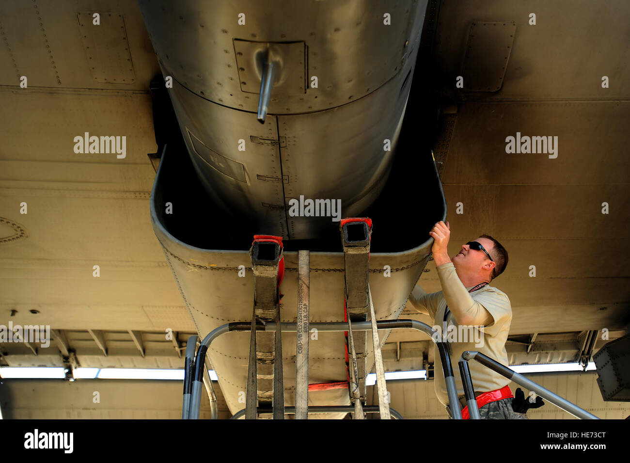 AC-130U gunship Crew Chief SrA. Christopher Gibson from the 4th Aircraft Maintenance Squadron, attaches a panel back  on to the plane during routine maintenance on January 28,2011 at Hurlburt Field, Fla. The AC-130U 'Spooky' gunship is the primary weapon of Air Force Special Operations Command. Its primary missions are close air support, air interdiction and armed reconnaissance. The U model is an upgraded version of the H and is equipped with side firing, trainable 25mm, 40mm, and 105mm guns. ( Master Sgt. Jeremy T. Lock) (Released) Stock Photo