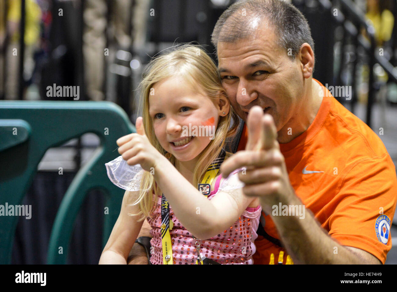 160508-F-WU507-005: Team Netherlands Army wounded warrior athlete Paul Gommers and his daughter, Daimy, pose for the Team Netherlands archery coach, prior to Gommers competing in the archery competition at the ESPN Wide World of Sports complex at Walt Disney World, Orlando, Fla., May 8, 2016.  A total of three medals will be awarded in the event.  Senior Master Sgt. Kevin Wallace/) Stock Photo