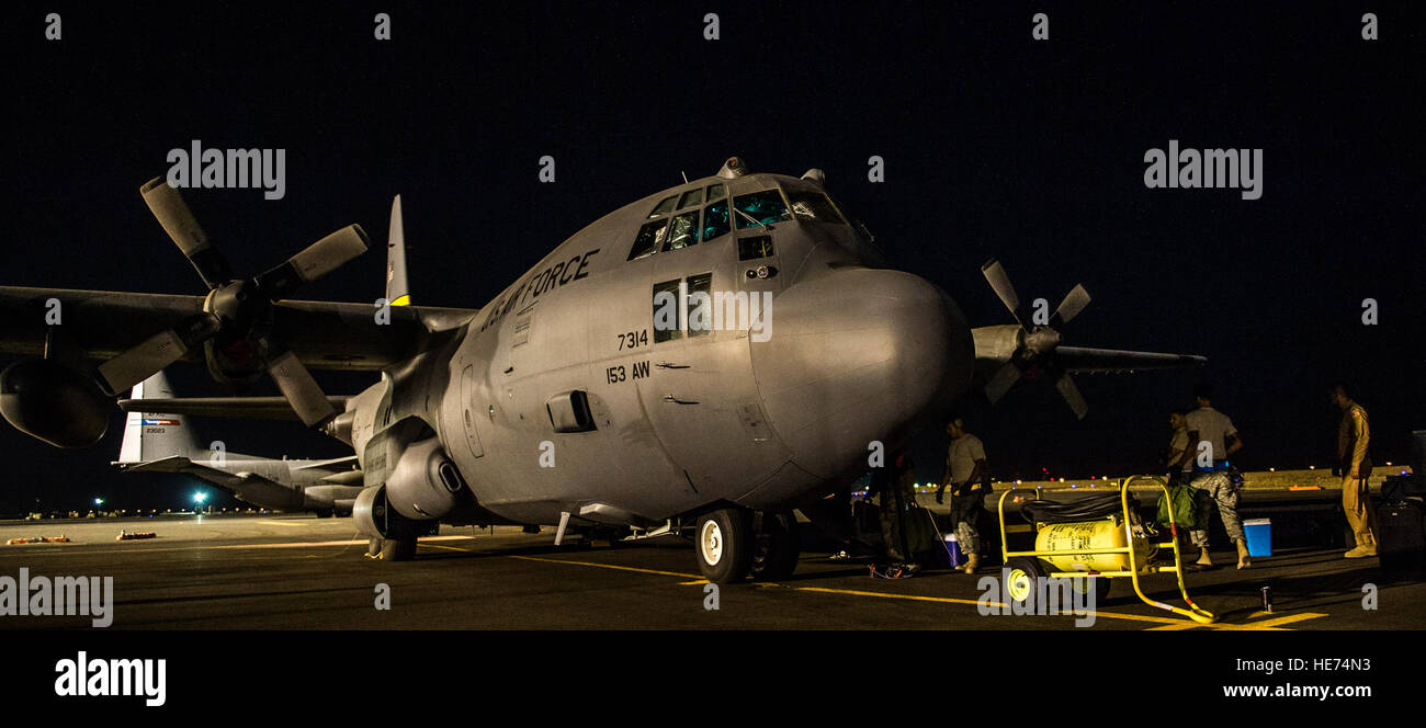 Airmen from the U.S. Central Command area of responsibility prepare a C-130H Hercules for take-off prior to a humanitarian aid mission Aug. 9, 2014. To date, in coordination with the government of Iraq, U.S. military aircraft have delivered more than 52,000 meals and more than 10,600 gallons of fresh drinking water, providing much-needed aid to the displaced Yazidis, who urgently require emergency assistance.  Staff Sgt. Jeremy Bowcock) Stock Photo
