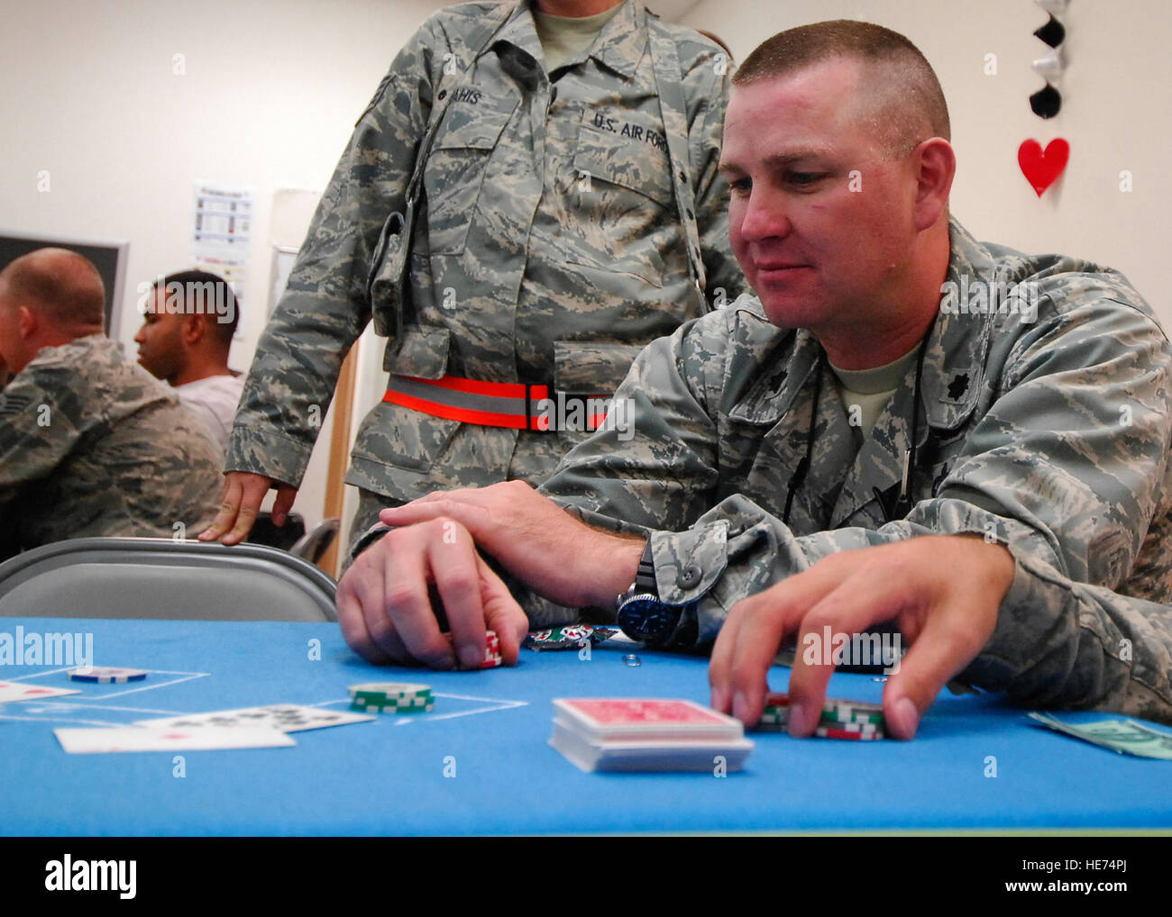 Lt. Col. Tommy James, vice commander of the 455th Expeditionary Mission Support Group, anxiously awaits to see the dealers cards during an game of Black Jack, Sept. 28. The 455th Air Expeditionary Wing 5/6 club held the first ever Casino Night, which was a way to bring U.S. and Coalition Forces together for a morale boosting event.  The attendees were given play money to play games such as black jack, poker, craps and roulette. The staff and technical sergeants make up the 5/6 club who provide great ways to spread morale. Col. James, a Rogersville, Ala. native, is deployed from the Alabama Air Stock Photo
