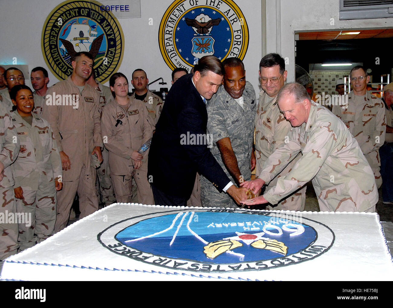 In the joint environment of the camp, right to left, Navy Rear Adm. James M. Hart assists Col. John M. Crocker, Brig. Gen. Alfred J. Stewart and Ambassador W. Stuart Symington in cutting the cake to celebrate the Heritage to Horizons theme of the Air Force's 60th birthday. Hart is the Combined Joint Task Force - Horn of Africa commander, Crocker is the 449th Air Expeditionary Group commander and Air Component Coordination Element director, Stewart is the Central Command director of mobility forces and Symington is the United States Ambassador of Djibouti and grandson of the first Secretary of  Stock Photo