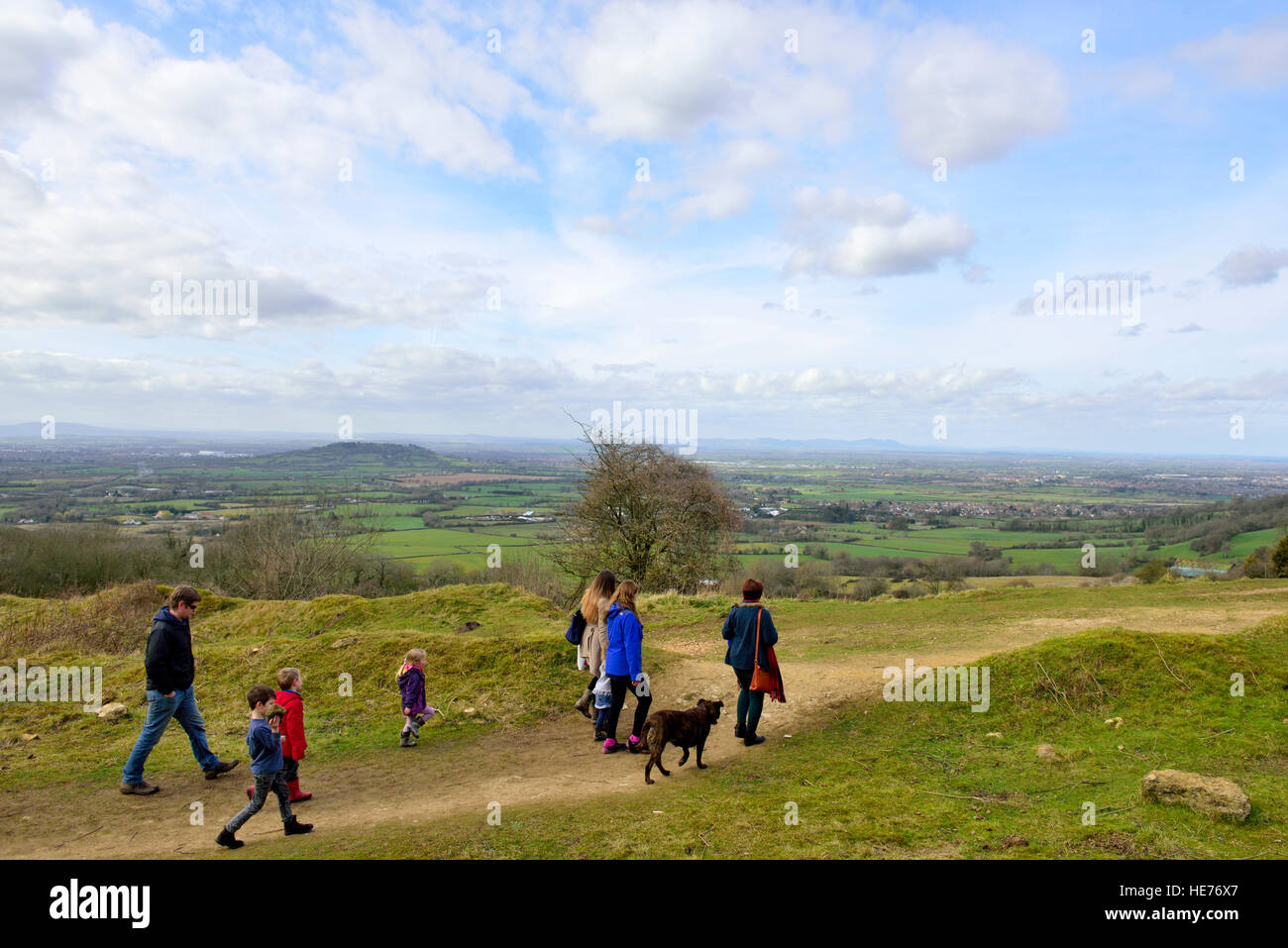 Family walking path on Cotswolds Way overlooking vale of the River Severn, Gloucestershire, England Stock Photo