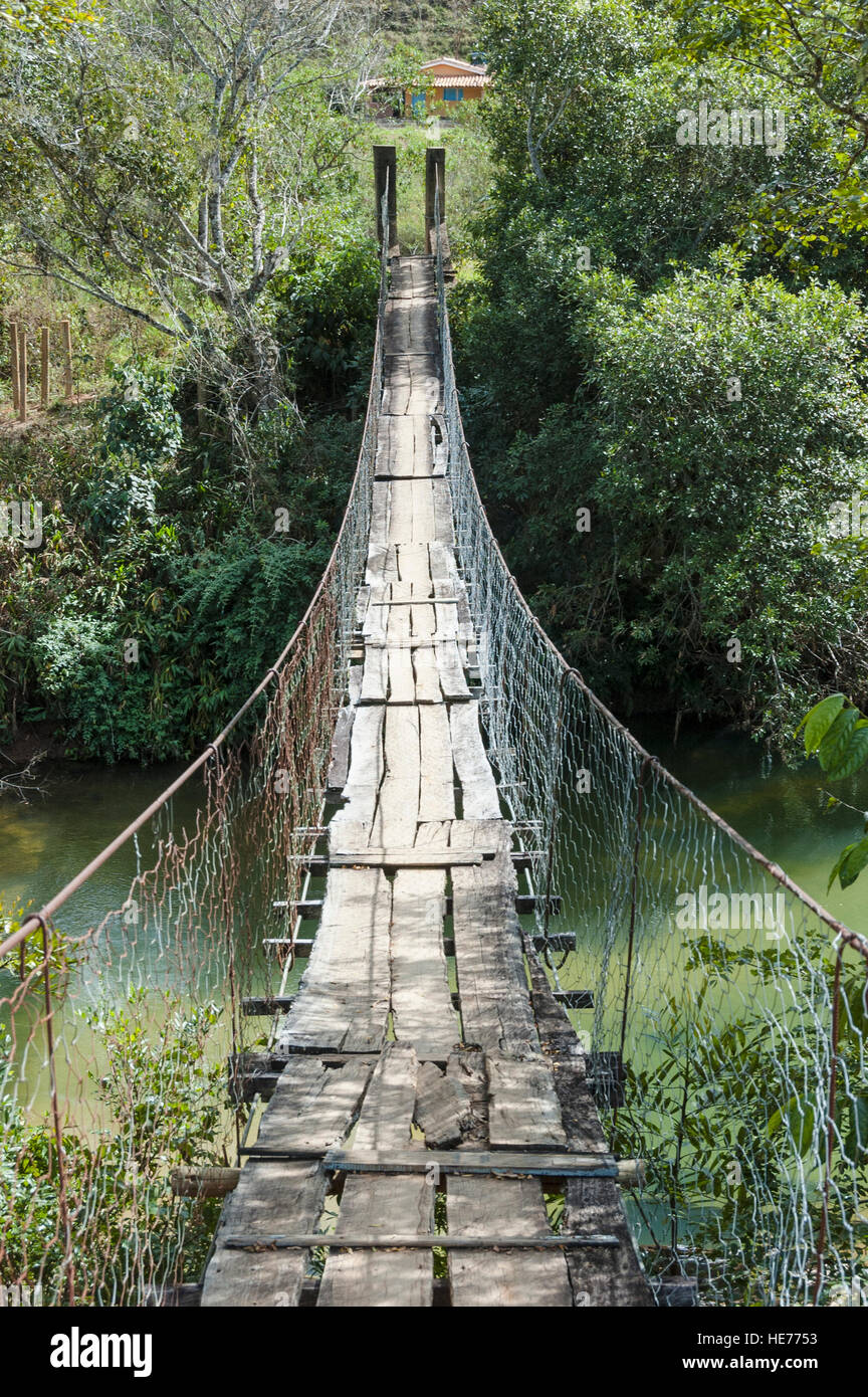 A suspension wood bridge in disrepair over the Sao Francisco River in Serra da Canastra, Minas Gerais, Brazil. Stock Photo
