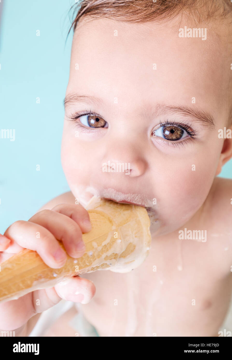 Portrait of Cute Toddler Girl Eating Melting Ice Cream Stock Photo