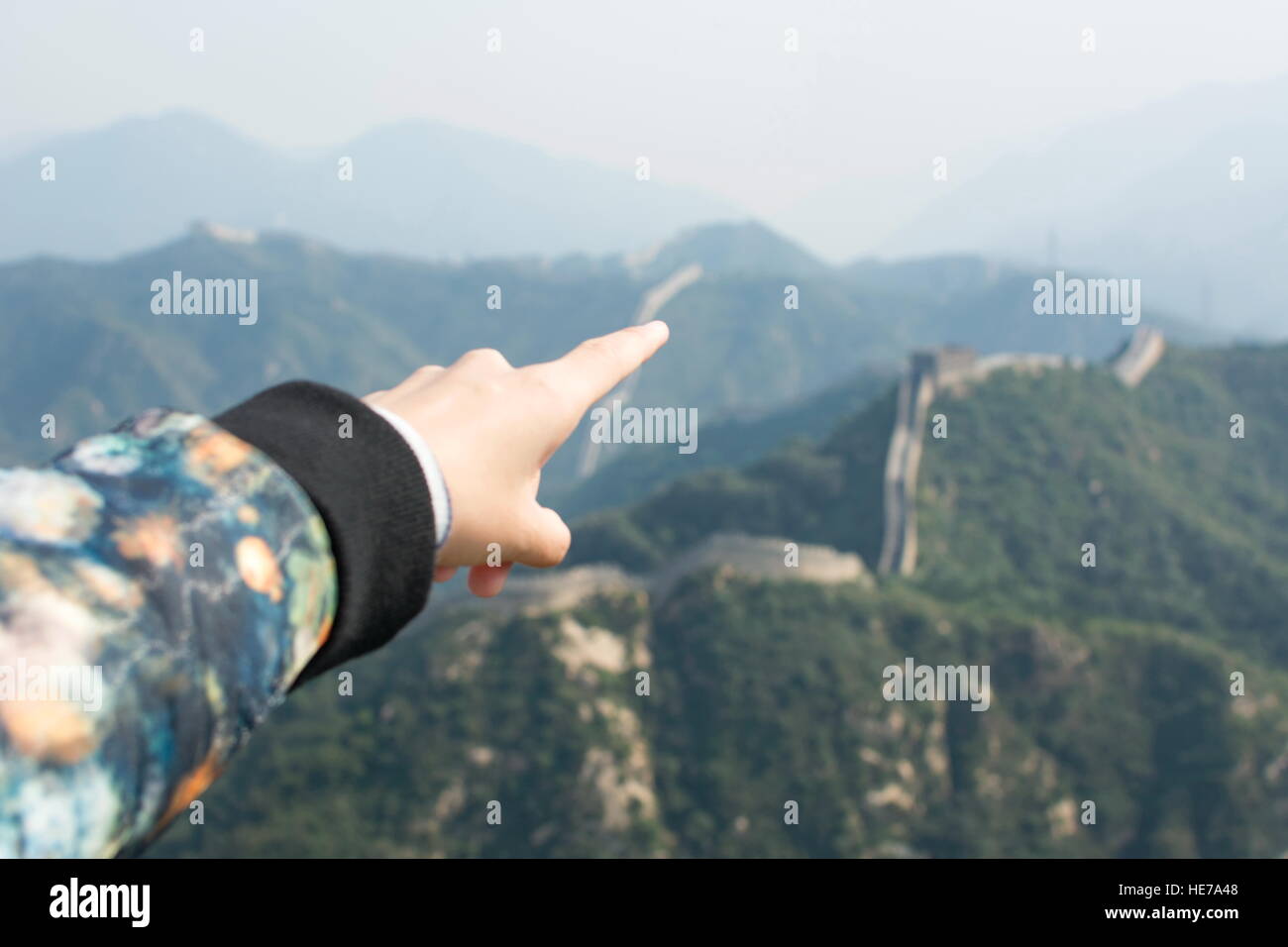 Female hand pointing the Great Wall of China, lets go there Stock Photo