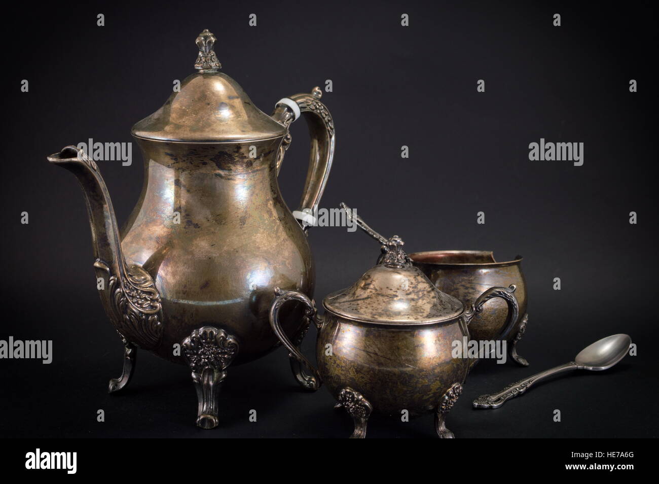Old silver kettle utensils on black background Stock Photo