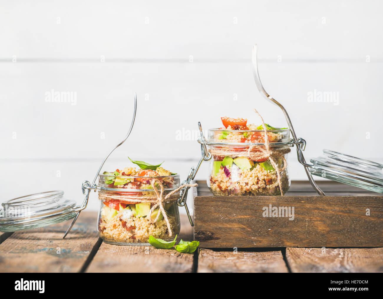 Homemade jar quinoa salad with tomatoes, avocado and basil Stock Photo
